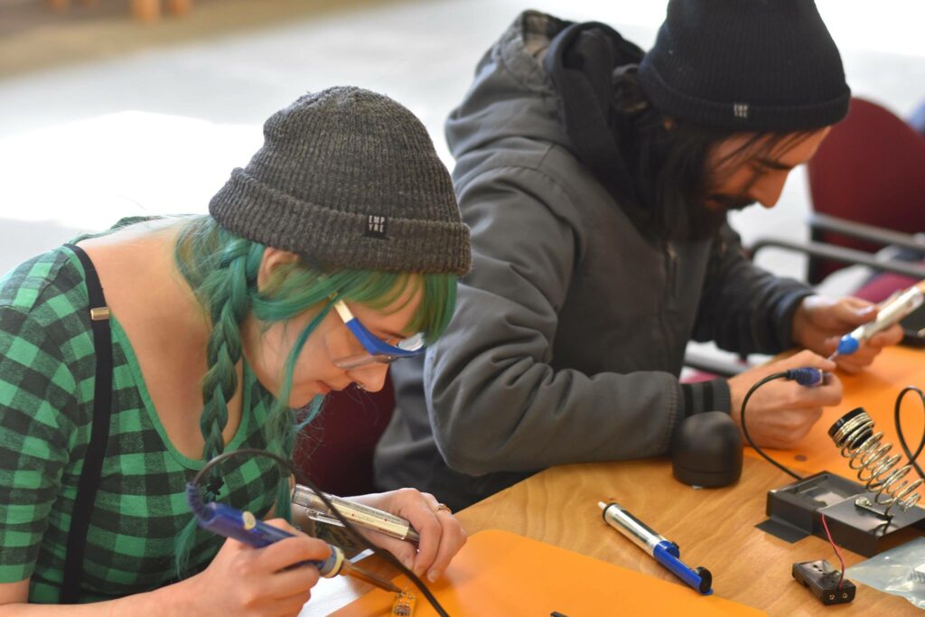 teens learning how to solder