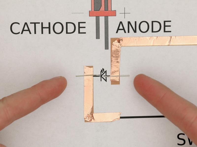 LED legs pulled part onto paper circuit